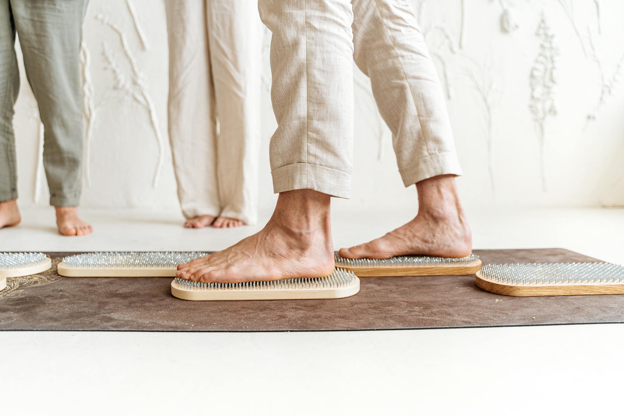 Close-up of feet on a wooden acupressure board, promoting relaxation and wellness.